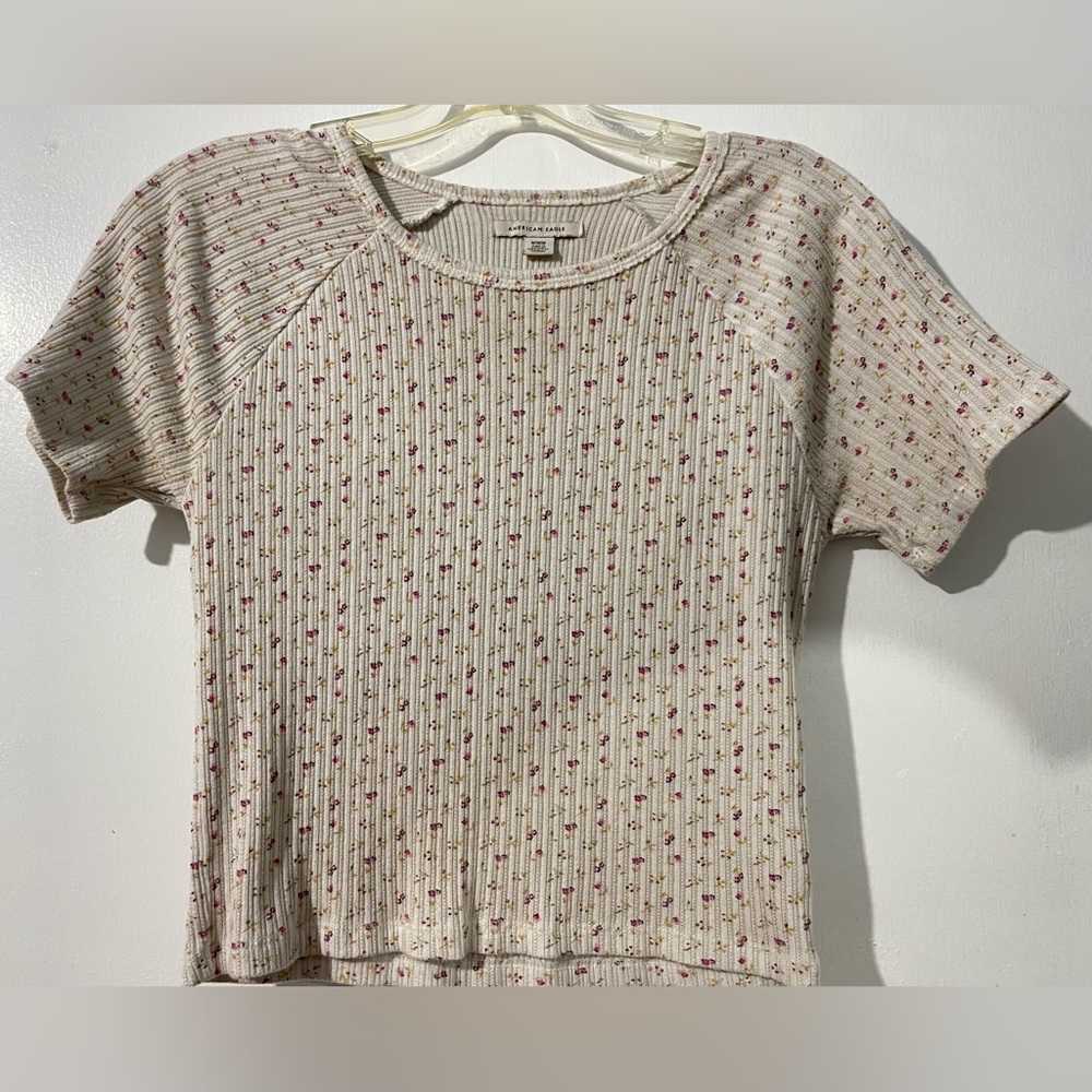 White and pink floral shirt.